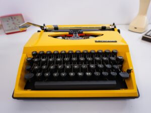 Vintage 1970’s Triumph (Adler) Tippa Portable Typewriter - Yellow, QWERTY Layout with Original Case