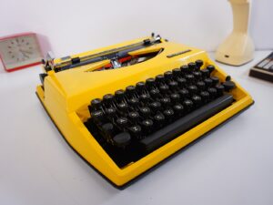 Vintage 1970’s Triumph (Adler) Tippa Portable Typewriter - Yellow, QWERTY Layout with Original Case