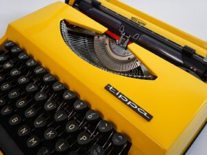 Vintage 1970’s Triumph (Adler) Tippa Portable Typewriter - Yellow, QWERTY Layout with Original Case