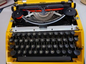 Vintage 1970’s Triumph (Adler) Tippa Portable Typewriter - Yellow, QWERTY Layout with Original Case